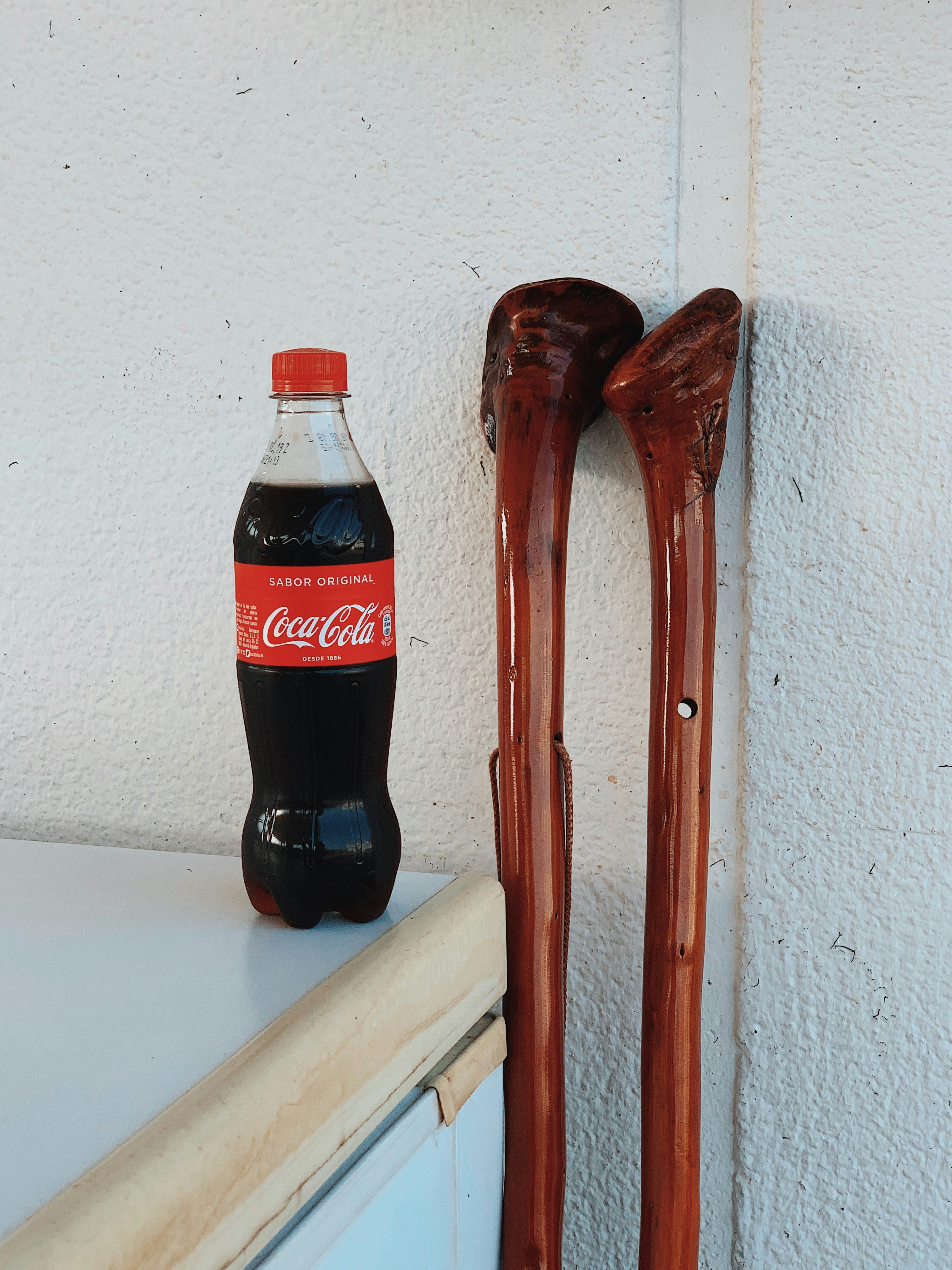 Coca-Cola bottle on white surface